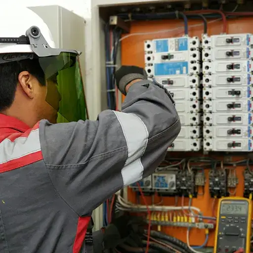 Handyman performing minor electrical panel repair and fixture installation